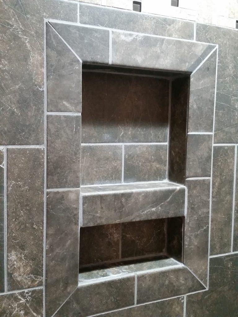 A close-up of the shower shelf.