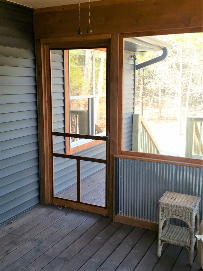 A view of the outside door from inside the screened-in porch.